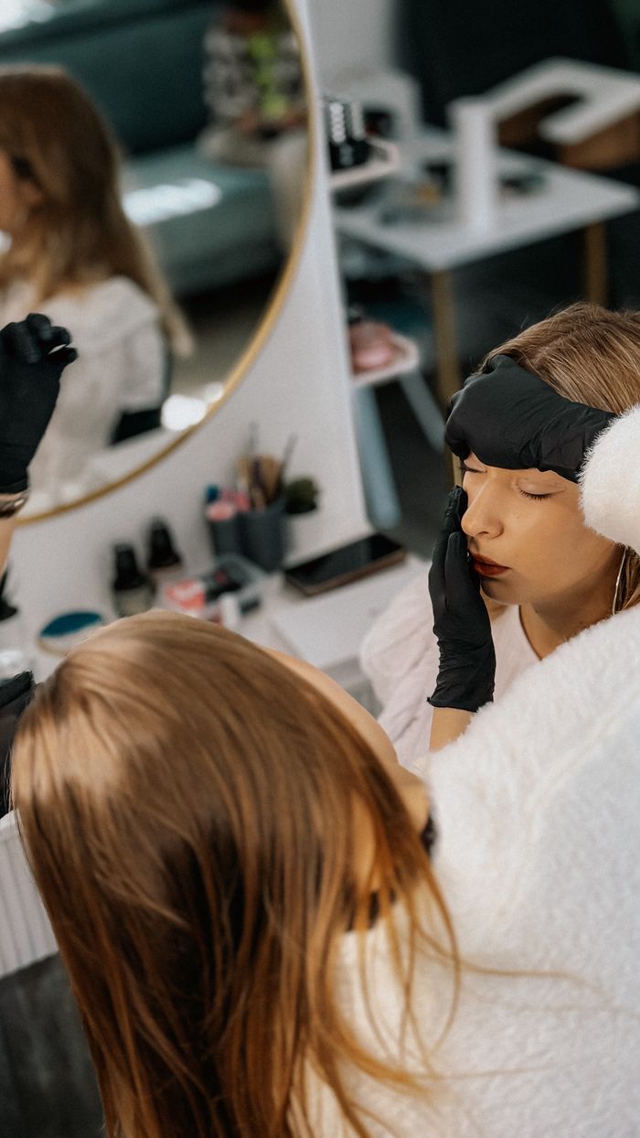 A woman enjoys a relaxing skincare treatment at a beauty salon.